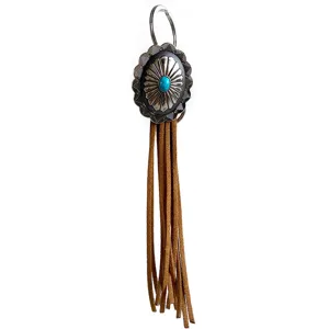 Vintage Western fringe keychain with concho and turquoise stone, detailed close-up view.