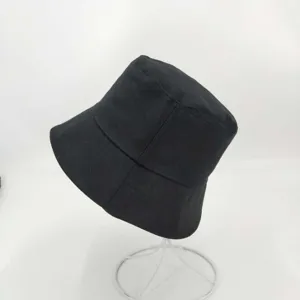 Classic black cotton bucket hat for men and women, casual plain sun protection cap.