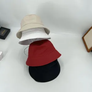 Classic cotton bucket hat for men and women, solid color casual sun cap for outdoor wear.