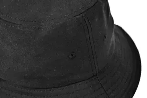 Close-up detail of black cotton bucket hat showing fine stitching and ventilation eyelet.