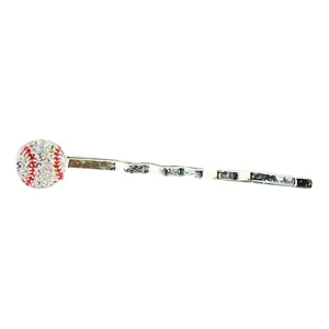 Close-up view of sparkly baseball bobby pin, showing detailed rhinestone hair accessory.