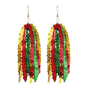 Sparkling long sequin tassel earrings in red, green and gold, festive party jewelry details.