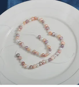 Close up view of natural freshwater baroque pearls in assorted candy colors with horizontal holes.