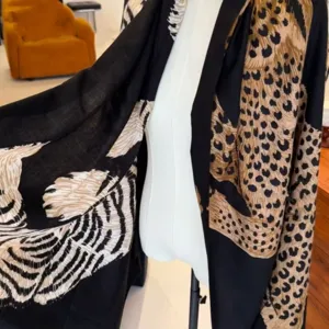 Vintage leopard print shawl for women, chic black and beige animal pattern scarf detail.