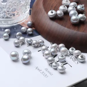 Grey freshwater pearl button detail shot showing the glossy surface and metal loop attachment.