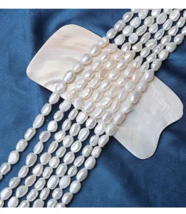 Close-up detail of 6-7mm irregular baroque natural freshwater pearls on mother of pearl shell.