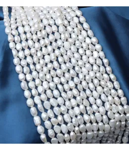 Detailed close-up of 6-7mm baroque natural freshwater pearl strands with glossy white luster.