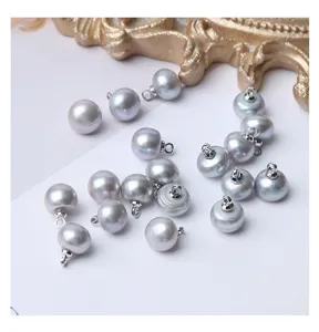 Close-up of grey freshwater pearl buttons with loops, perfect for DIY clothing and silk shirts.