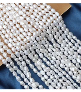 Close-up detail of 6-7mm baroque freshwater pearl strands, irregular natural pearl details.