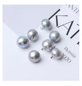 Grey freshwater pearl buttons detail shot, ideal for garments and DIY sewing projects.