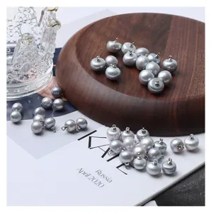 Detailed shot of gray freshwater pearl buttons with metal loops, ideal for DIY clothing.