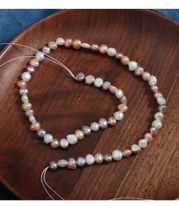 Close-up of 5-6mm natural candy color baroque freshwater pearl strands, gorgeous shiny detail.