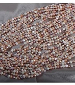 Detailed shot of multicolored freshwater baroque pearls strand, glossy candy color beads, 35cm.