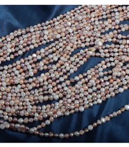 Detail view of colorful baroque freshwater pearl strands, 5-6mm irregular gemstone beads.