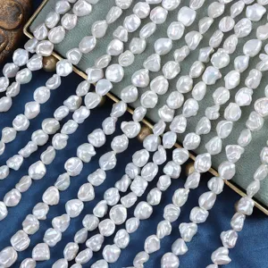 Close-up detail shot of 7-8mm natural freshwater baroque pearl strands, irregular white pearls.