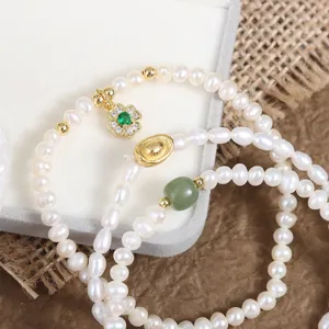 Natural freshwater pearl bracelet with clover charm and jade bead, elegant daily jewelry.