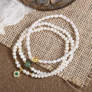 Natural freshwater pearl bracelet with lucky four leaf clover and green jade beads, elegant jewelry.