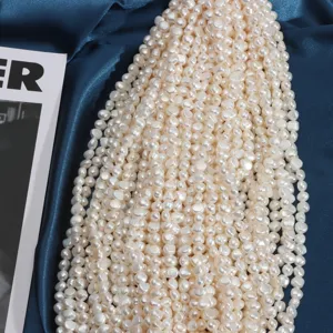 Close-up detail of baroque freshwater pearl strands, white irregular loose DIY jewelry beads.