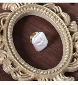Detailed close-up of a vintage square baroque freshwater pearl brooch collar pin.