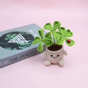 Detailed close-up of a handmade crochet four-leaf clover potted plant desktop decor.