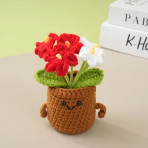 Handcrafted crochet potted plant with red and white flowers, cute desktop decor ornament.
