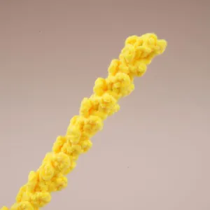 Branche de fleur au crochet jaune artisanat en fil tricoté bricolage déco maison gros plan