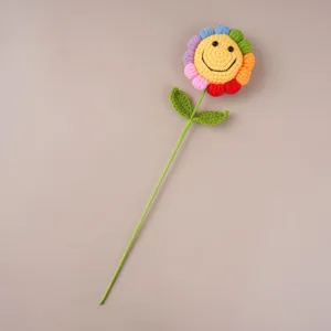 Handcrafted crochet smiley flower detail, colorful knitted wool flower stem close-up display.