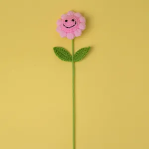 Handmade crochet cute pink smiley flower detail, soft wool craft for decoration or nice gift.