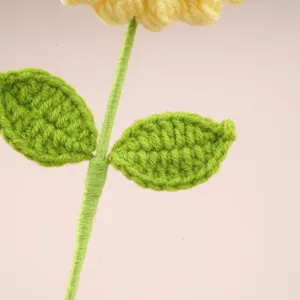 Handmade crochet sunflower stem and leaves detail, lovely knitted wool flower decor.