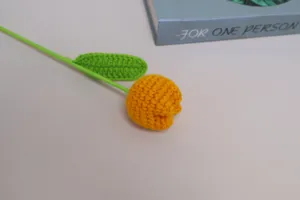 Handmade crochet tulip flower detail view, knitted yarn botanical decor piece for room style.
