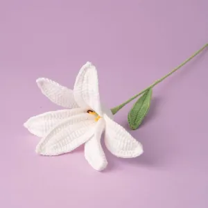 Handmade crochet white lily flower detail view knitted floral ornament for home decor.