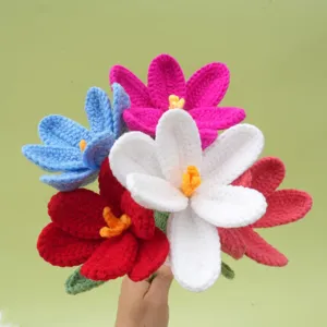 Close-up detail of handmade crochet flower bouquet, vibrant multicolored yarn blooms and green leaves.