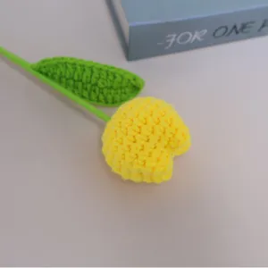 Handcrafted crochet wool tulip flower main view, vibrant yellow bloom with green stem and leaf for decor.