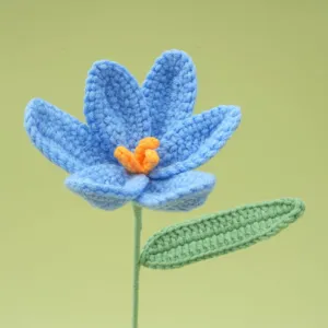 Handmade crochet blue flower detail, exquisite wool craft, delicate stem and leaf.