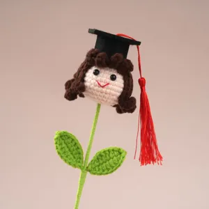 Handmade crochet graduation doll with black cap and red tassel, cute gift for graduation season.