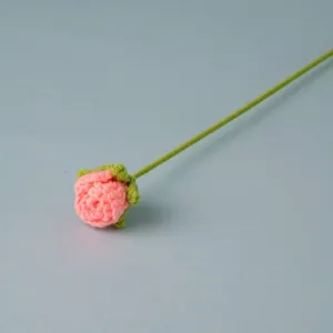 Handmade crochet pink rose flower detail view, beautiful knitted artificial flower single stem.