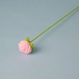 Handmade crochet pink rose flower detail, exquisite knitted floral stem for home decor.