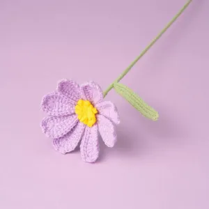 Handmade crochet purple flower detail view, cute wool knitted artificial flora for cozy decor.