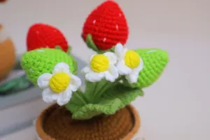 Handmade crochet strawberry potted plant detail, cute knitted flower decor for home room