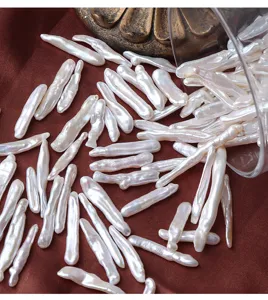 Detail shot of natural baroque freshwater toothpick pearls loose beads, irregular DIY craft material.