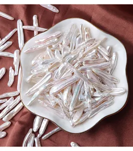 Detail view of natural freshwater baroque toothpick pearls, long loose beads for DIY jewelry.