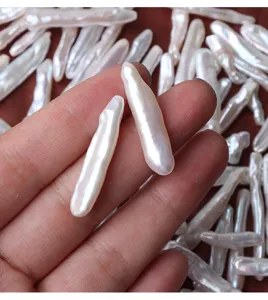 Detailed view of natural baroque freshwater toothpick pearls, perfect for DIY handmade jewelry.