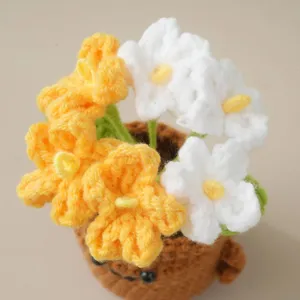 Handmade crochet flower potted plant closeup desk ornament yellow white floral decor detail