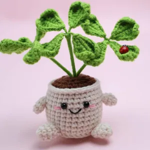 Handmade crochet four-leaf clover potted plant cute smiling face desktop knitted ornament.