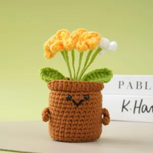 Handmade crochet potted flower desktop ornament detail, cute knitted plant decor for home study.