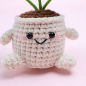 Handmade cute crochet potted plant desk ornament showing delicate hand-knitted details.