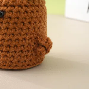 Handmade crochet brown yarn craft detail macro shot home decor desktop ornament gift