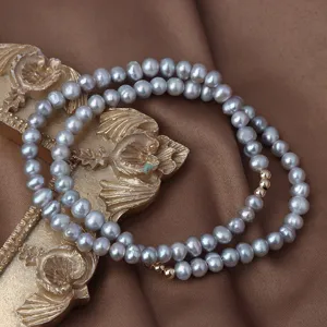 Graue Süßwasserperlen Armband mit Goldkugeln elegante einfache elastische Damenschmuck