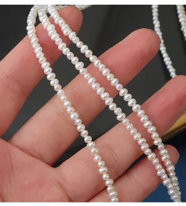 Detail view of 2.5-3mm natural freshwater potato pearls strand, smooth luster display.