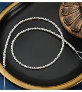 Natural freshwater small rice pearl strand 2.5-3mm detail view, smooth and delicate beads.